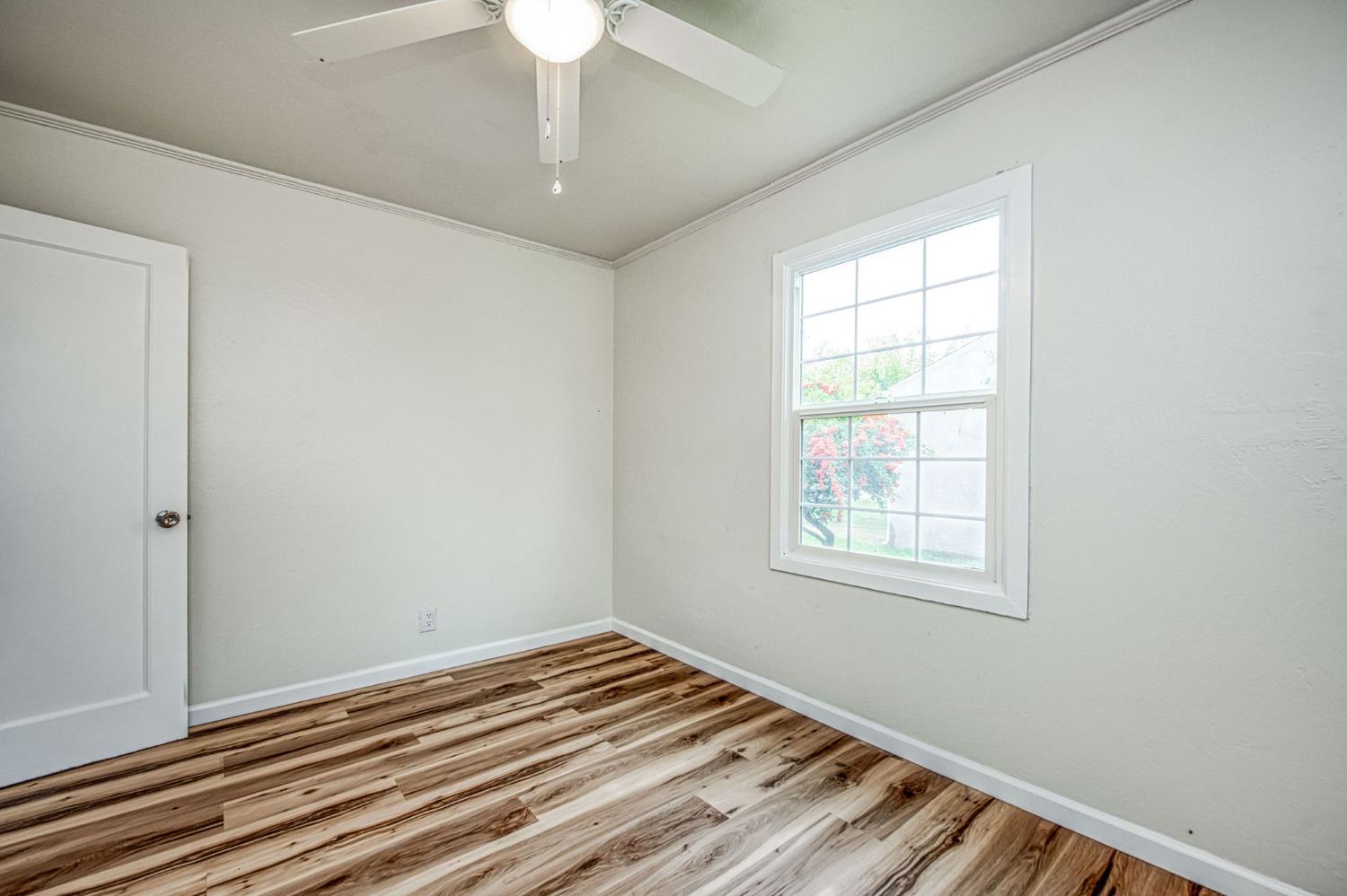 517 Rotan Avenue Madera, CA 93637 - Photo 19 of 32 a view of a room with wooden floor and chandelier fan