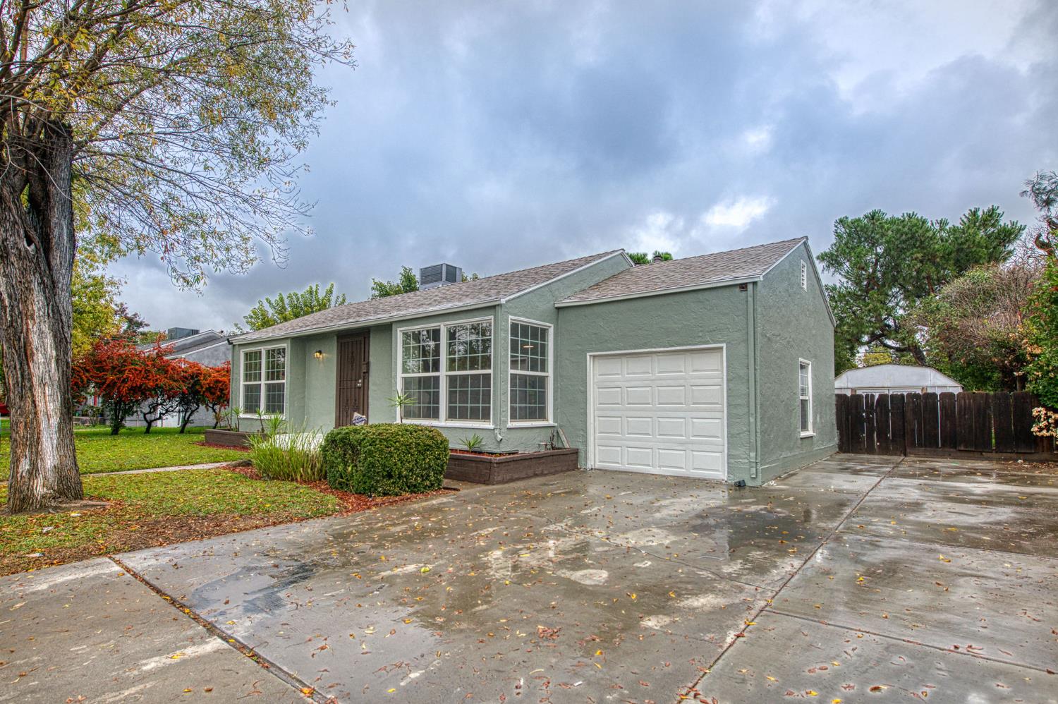 517 Rotan Avenue Madera, CA 93637 - Photo 3 of 32 a view of a house with a yard and garage