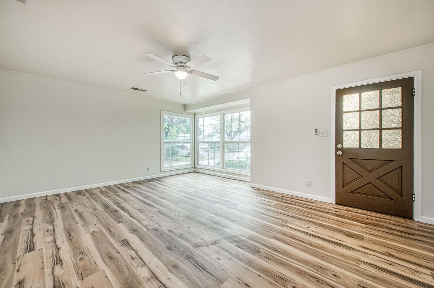 517 Rotan Avenue Madera, CA 93637 - Photo 4 of 32 wooden floor in an empty room with a window