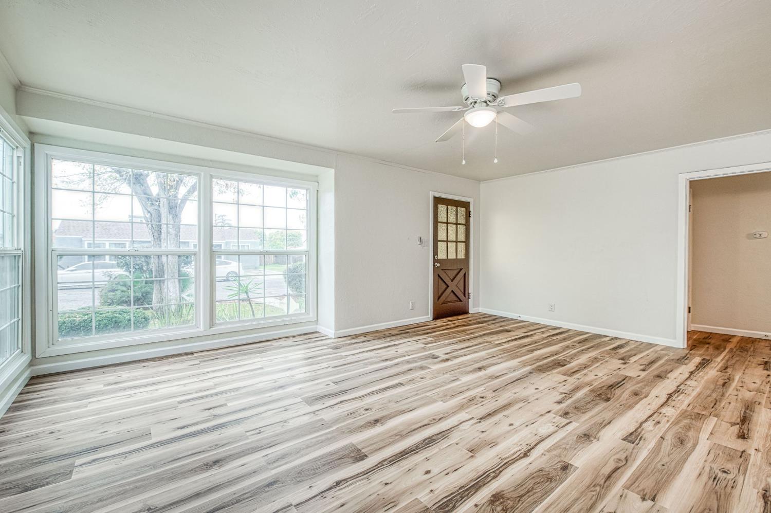 517 Rotan Avenue Madera, CA 93637 - Photo 6 of 32 a view of empty room with wooden floor and fan