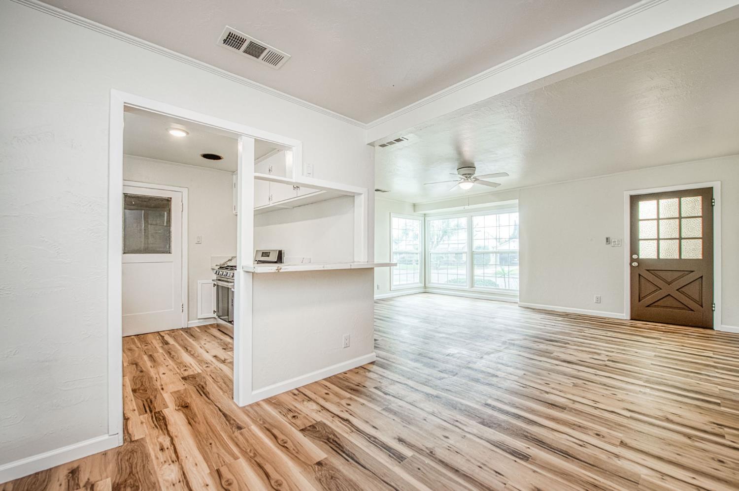 517 Rotan Avenue Madera, CA 93637 - Photo 7 of 32 a view of empty room with wooden floor and fan