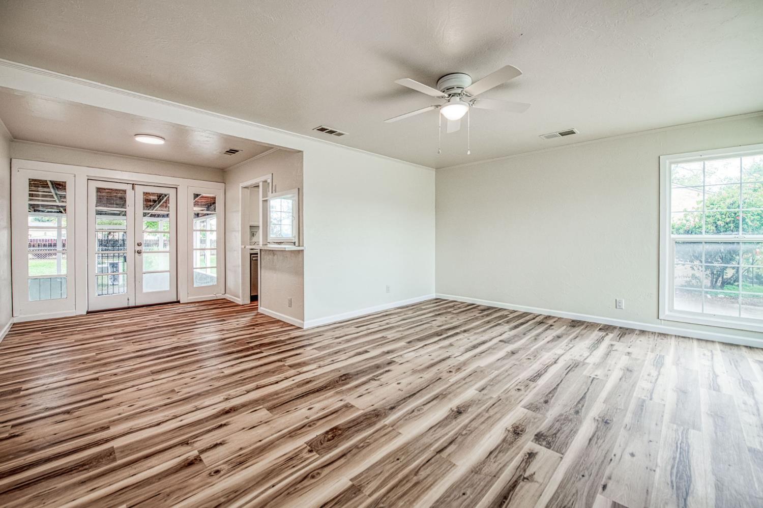 517 Rotan Avenue Madera, CA 93637 - Photo 8 of 32 a view of empty room with wooden floor and fan