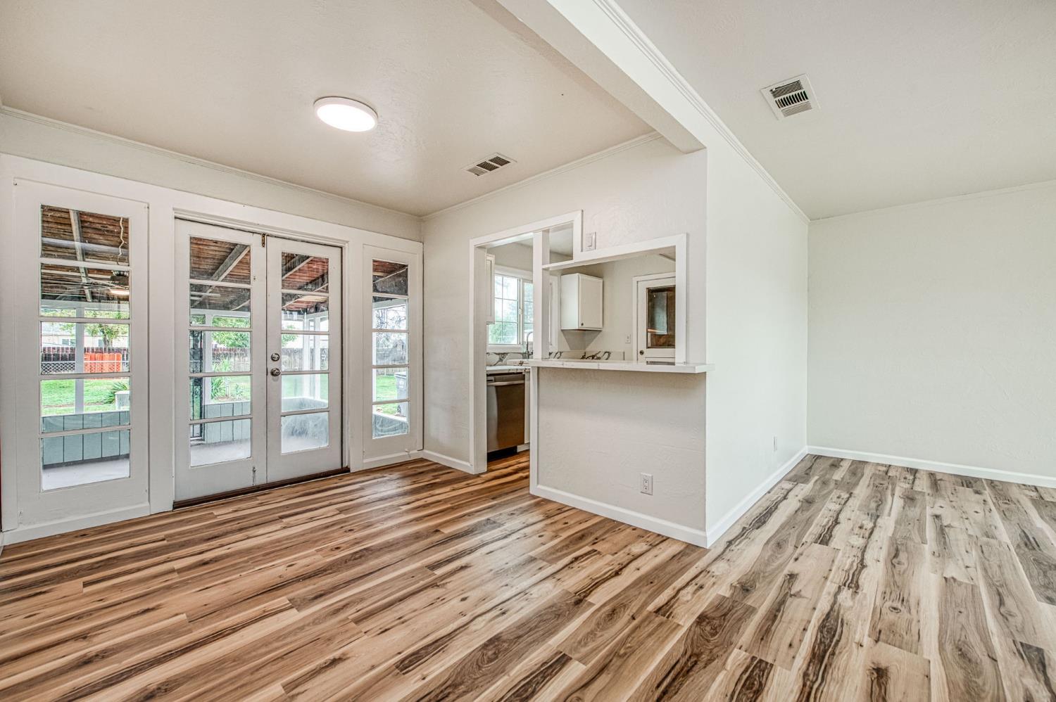 517 Rotan Avenue Madera, CA 93637 - Photo 9 of 32 a view of a room with wooden floor and windows