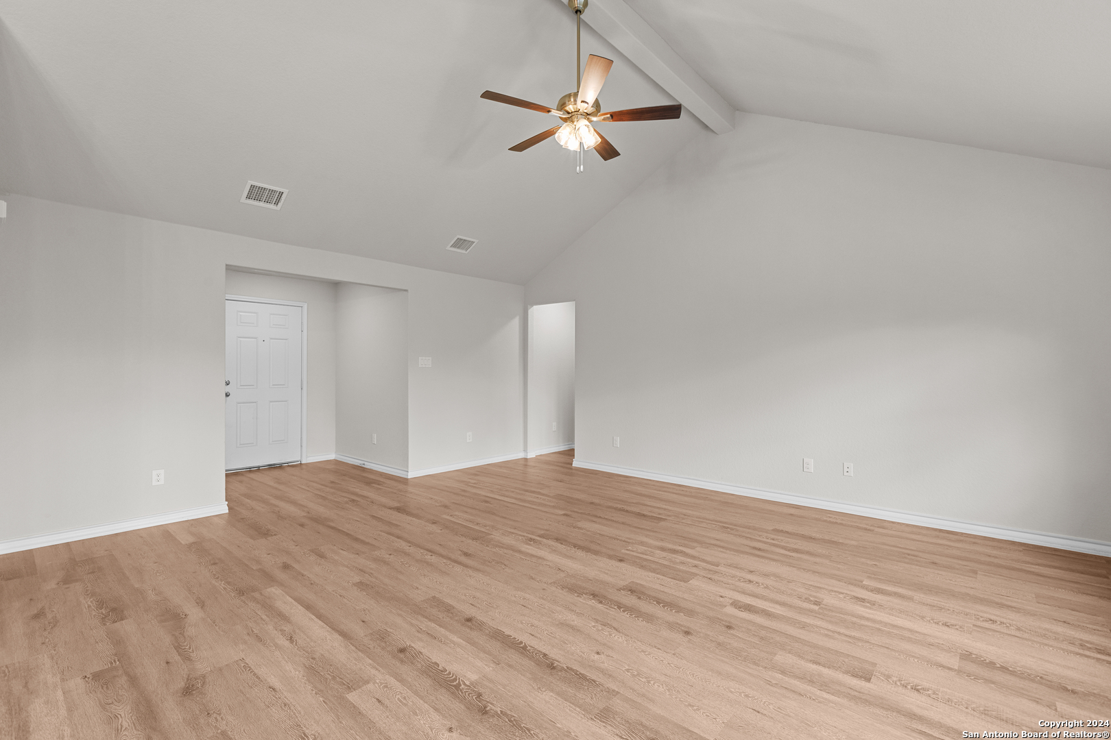 117 Sylas Hayes Loop Pleasanton, TX 78064 - Photo 15 of 38 a view of a livingroom with a ceiling fan and wooden floor