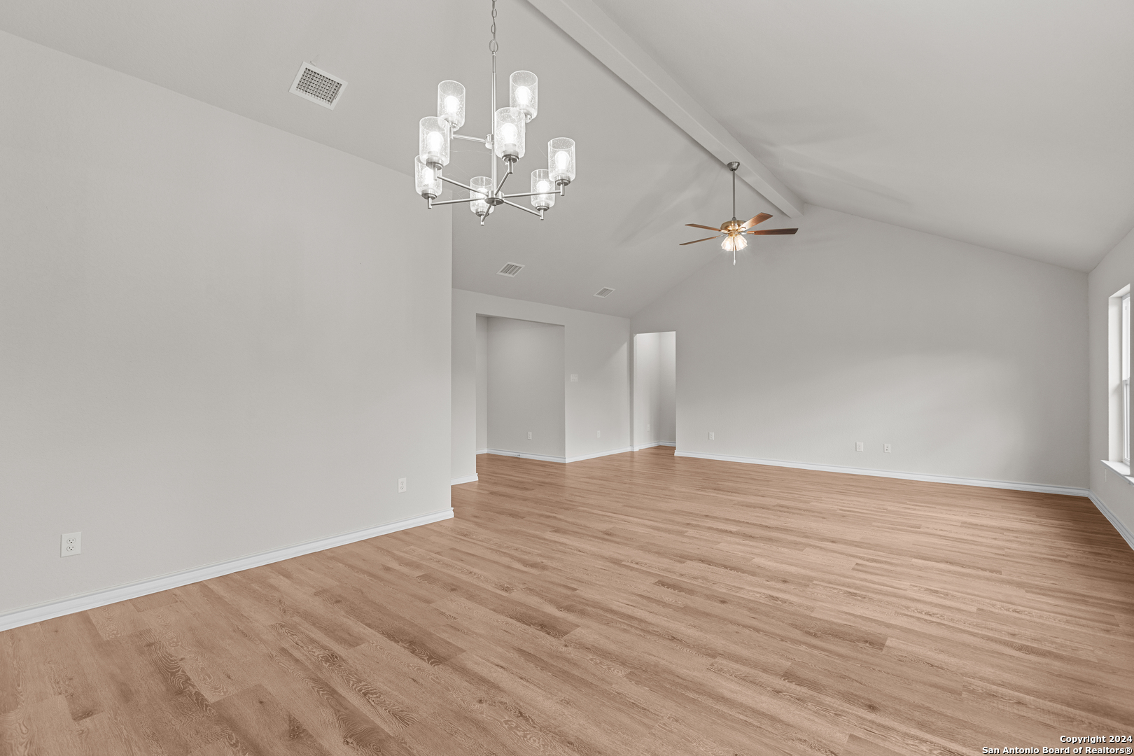 117 Sylas Hayes Loop Pleasanton, TX 78064 - Photo 16 of 38 a view of empty room with wooden floor and chandelier