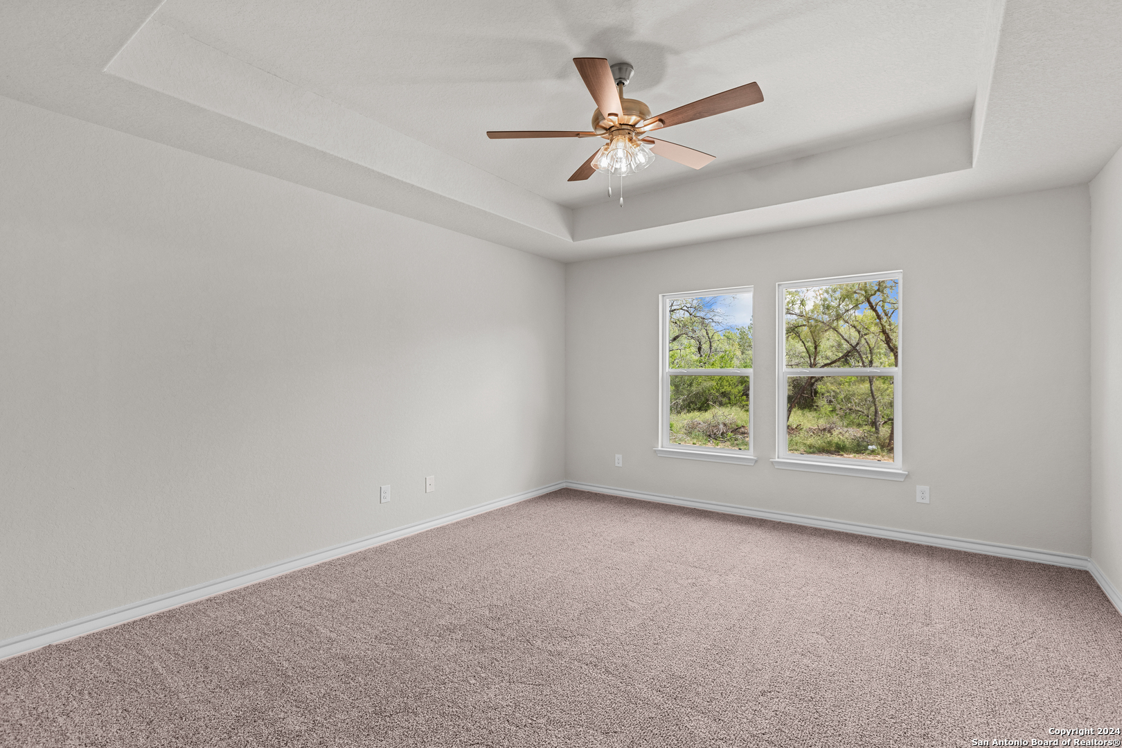 117 Sylas Hayes Loop Pleasanton, TX 78064 - Photo 27 of 38 an empty room with windows and fan