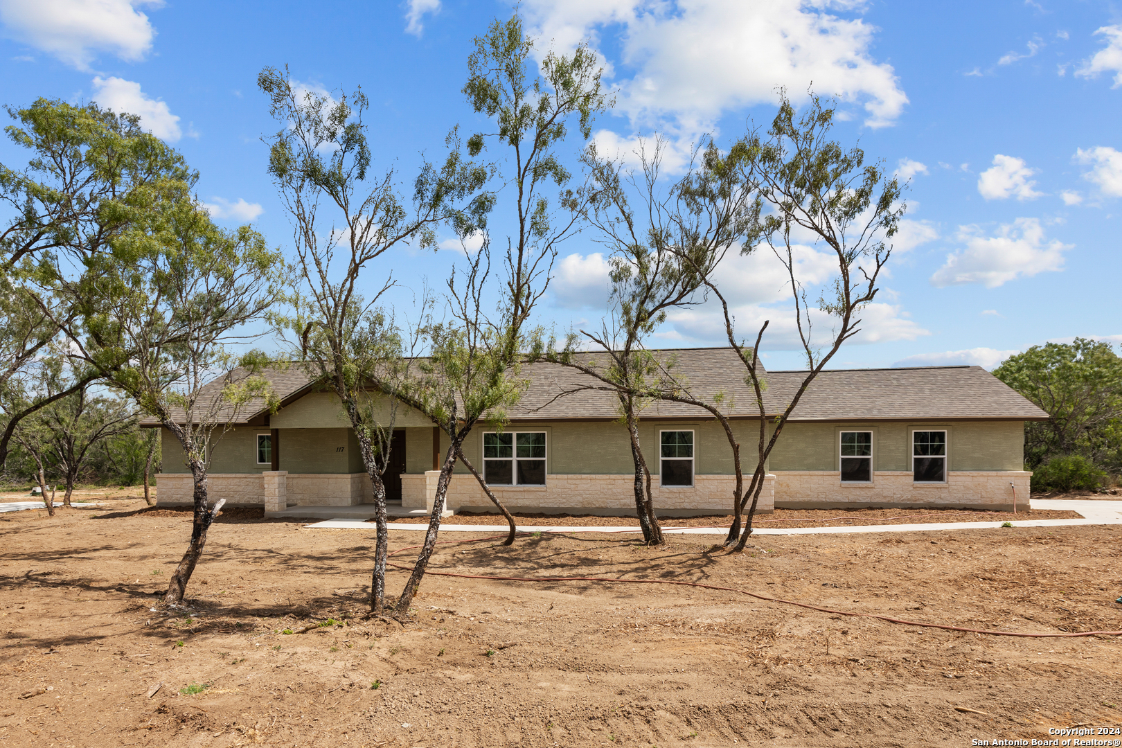 117 Sylas Hayes Loop Pleasanton, TX 78064 - Photo 3 of 38 a front view of a house with garden