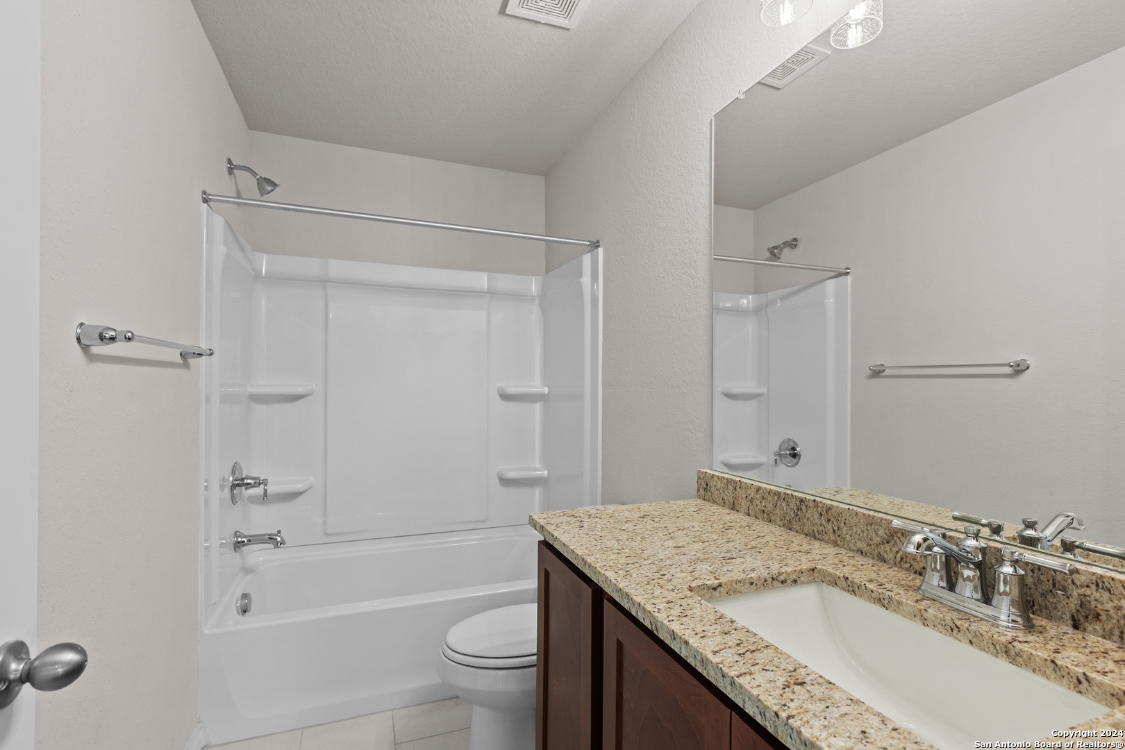 117 Sylas Hayes Loop Pleasanton, TX 78064 - Photo 34 of 38 a bathroom with a granite countertop sink a toilet and shower