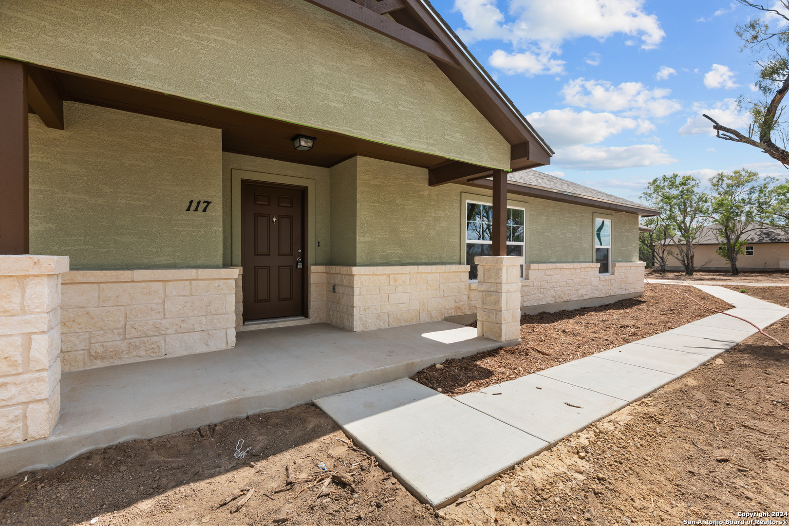 117 Sylas Hayes Loop Pleasanton, TX 78064 - Photo 6 of 38 a front view of a house with garden