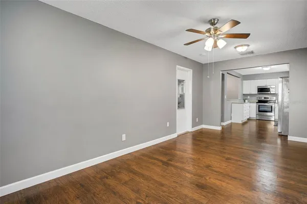 a view of a livingroom with a ceiling fan and entryway