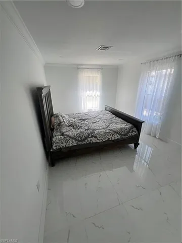 a bedroom with bed and window