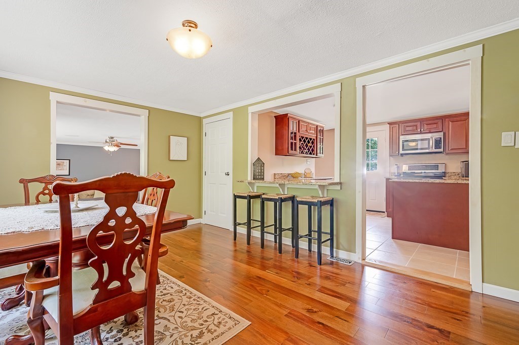 223 New Boston Road Sturbridge, MA 01566 - Photo 4 of 29 a view of a dining room with furniture and wooden floor