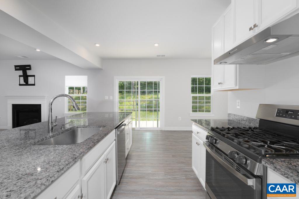 117 Island Hill Road Palmyra, VA 22963 - Photo 18 of 34 a kitchen with stainless steel appliances granite countertop a sink stove and cabinets