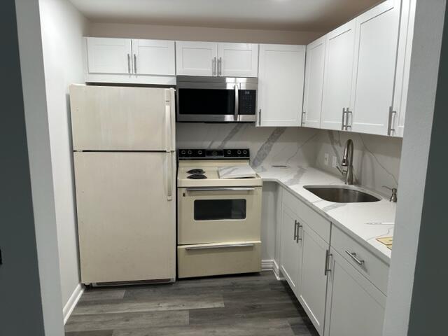 273 Suffolk F Boca Raton, FL 33434 - Photo 3 of 9 a kitchen with a refrigerator sink and cabinets