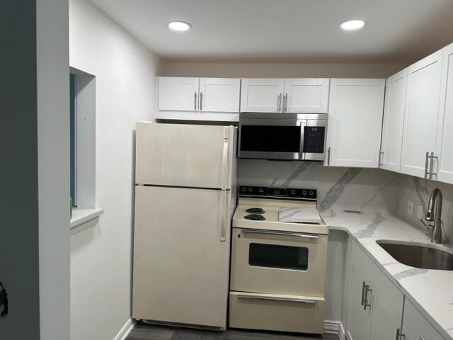 273 Suffolk F Boca Raton, FL 33434 - Photo 4 of 9 a kitchen with a refrigerator sink and cabinets