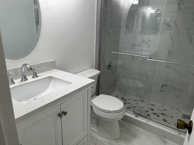 273 Suffolk F Boca Raton, FL 33434 - Photo 7 of 9 a bathroom with a sink a toilet and shower