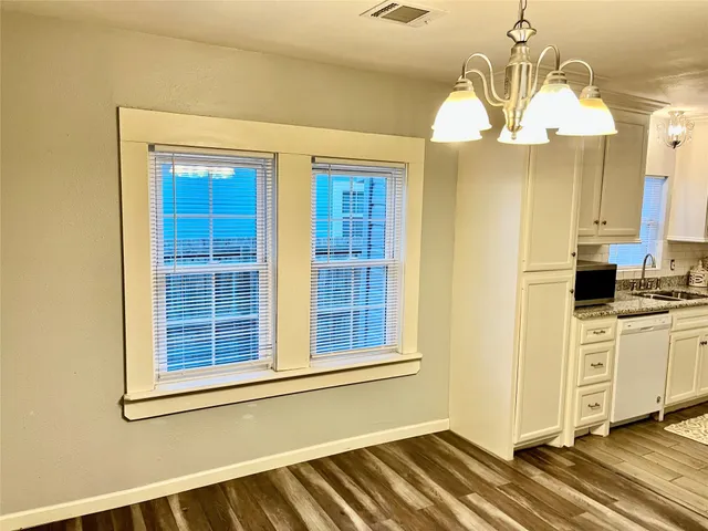 a view of a kitchen with granite countertop wooden cabinets and stainless steel appliances