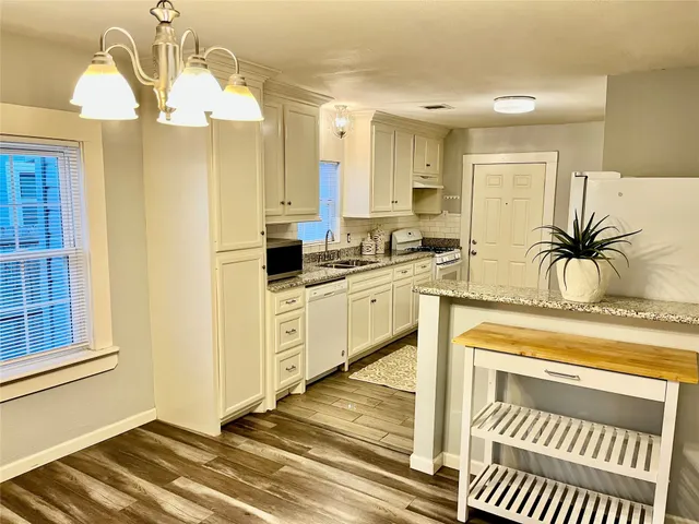 a kitchen with a sink stove and cabinets