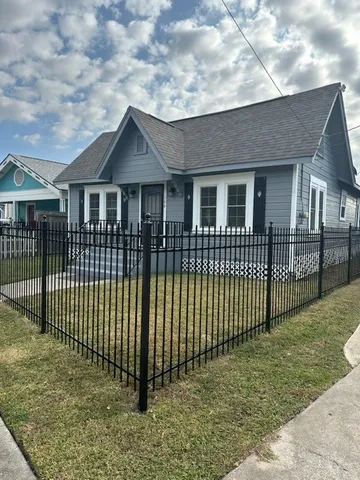 a view of a house with wooden fence