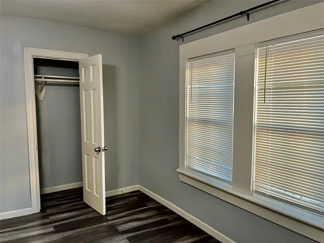 a view of a livingroom with wooden floor and a window