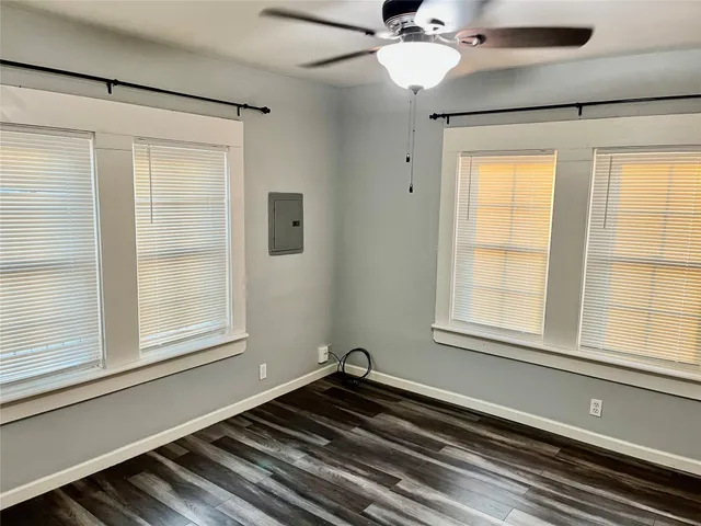 a view of a livingroom with wooden floor and a ceiling fan