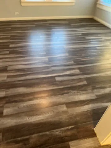 a view of a room with wooden floor