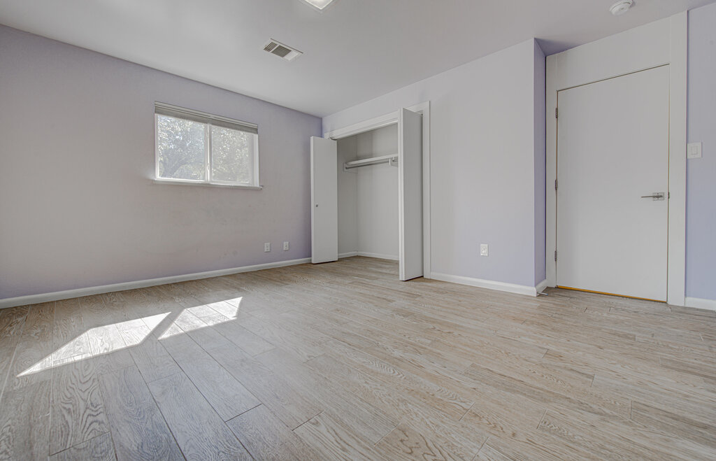 2400 Spring Creek Drive Austin, TX 78704 - Photo 13 of 38 Unfurnished bedroom featuring light wood-type flooring and a closet