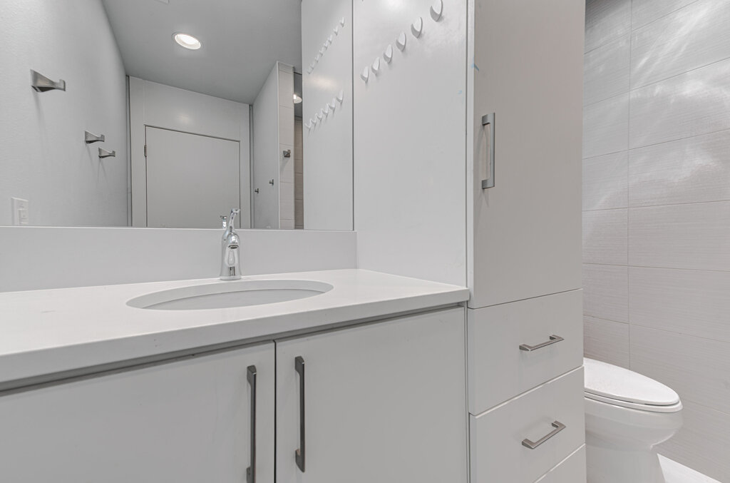 2400 Spring Creek Drive Austin, TX 78704 - Photo 14 of 38 Bathroom featuring vanity and tile walls
