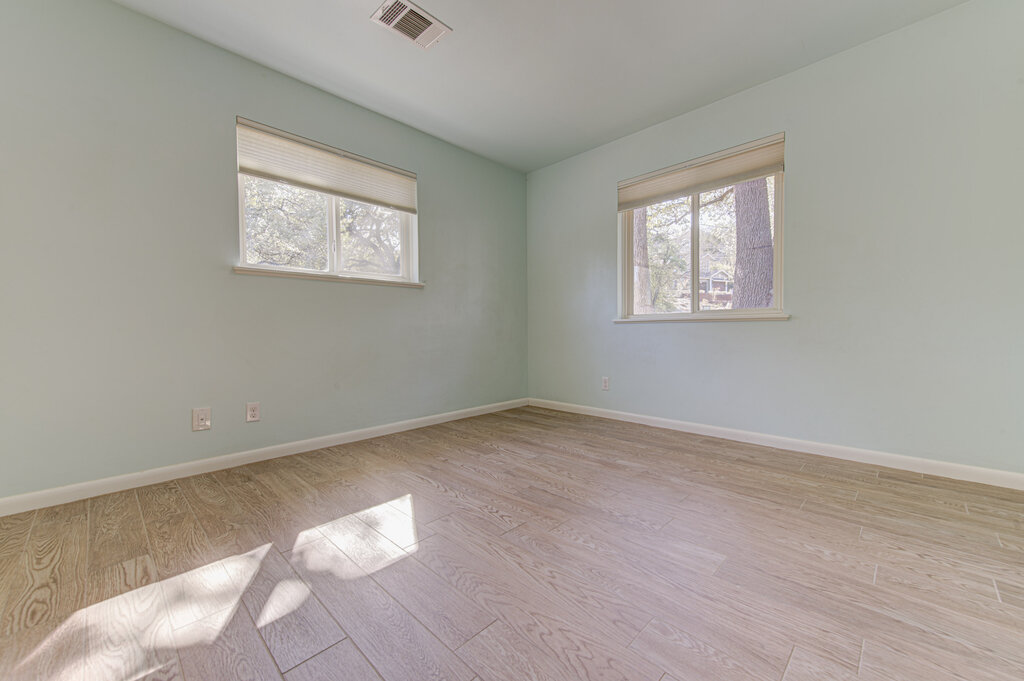2400 Spring Creek Drive Austin, TX 78704 - Photo 16 of 38 Empty room featuring light wood finished floors and healthy amount of natural light