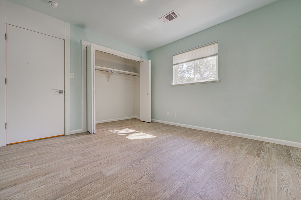 2400 Spring Creek Drive Austin, TX 78704 - Photo 17 of 38 Unfurnished bedroom featuring light wood finished floors and a closet
