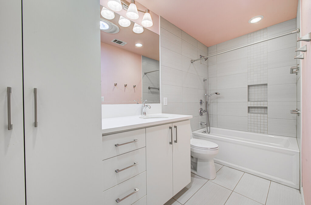 2400 Spring Creek Drive Austin, TX 78704 - Photo 18 of 38 Bathroom featuring shower / tub combination, vanity, light tile patterned flooring, and recessed lighting