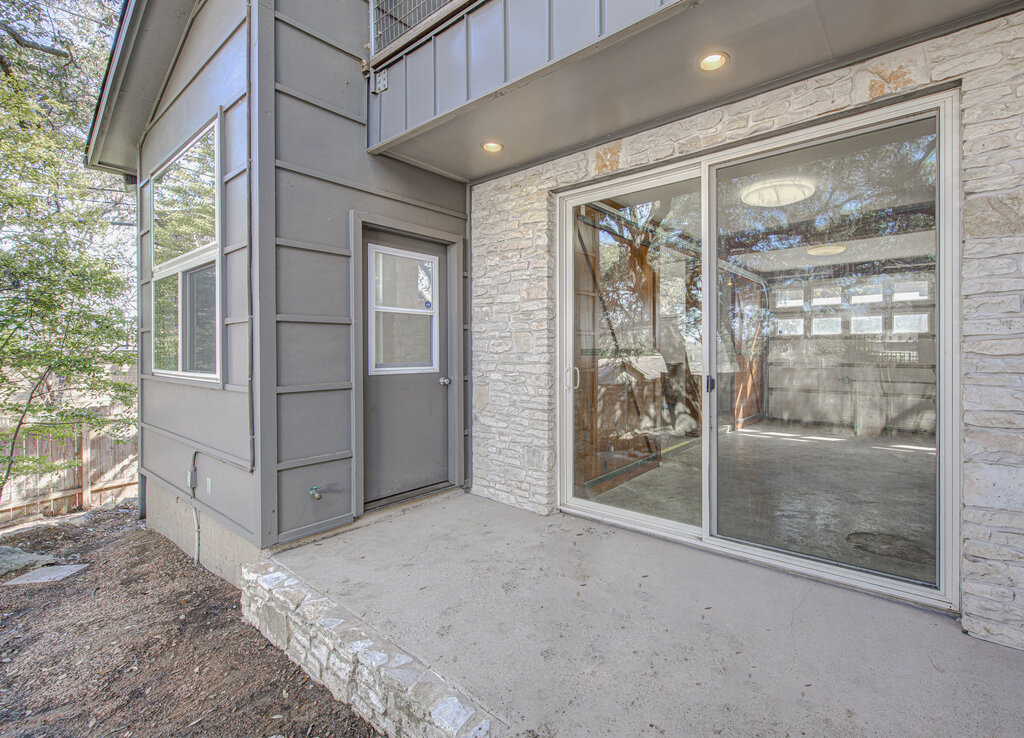 2400 Spring Creek Drive Austin, TX 78704 - Photo 26 of 38 Doorway to property featuring stone siding and a patio