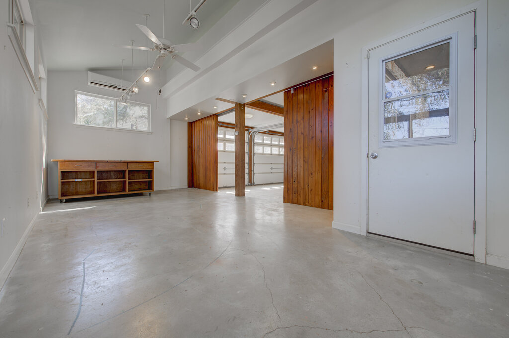 2400 Spring Creek Drive Austin, TX 78704 - Photo 27 of 38 Unfurnished room with concrete floors, a high ceiling, and ceiling fan