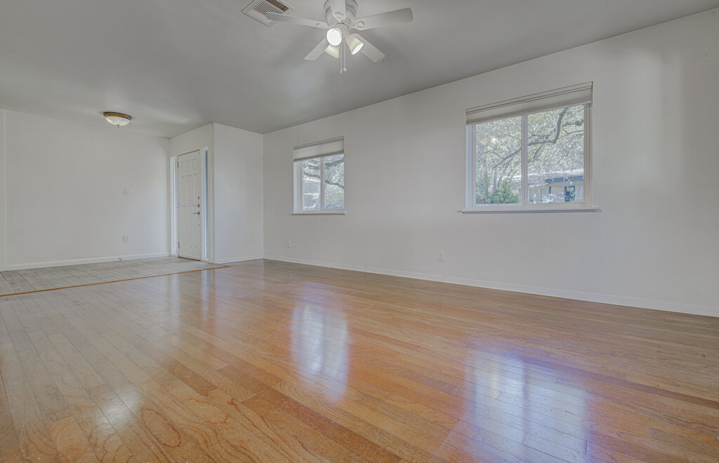 2400 Spring Creek Drive Austin, TX 78704 - Photo 3 of 38 Empty room featuring light wood-style flooring and ceiling fan