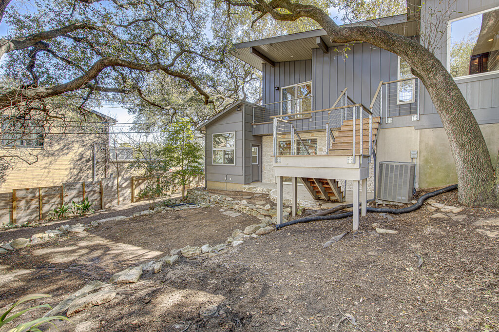 2400 Spring Creek Drive Austin, TX 78704 - Photo 33 of 38 Back of house with stairs and a balcony