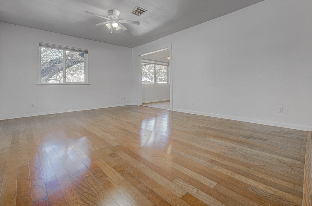 2400 Spring Creek Drive Austin, TX 78704 - Photo 4 of 38 Unfurnished room with light wood finished floors, healthy amount of natural light, and ceiling fan