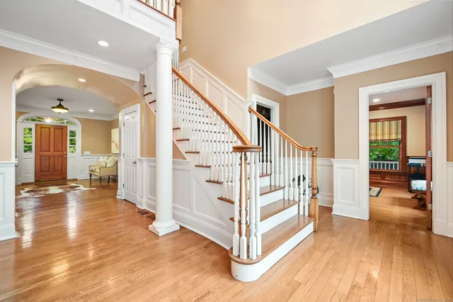 a view of a livingroom with wooden floor and stairs