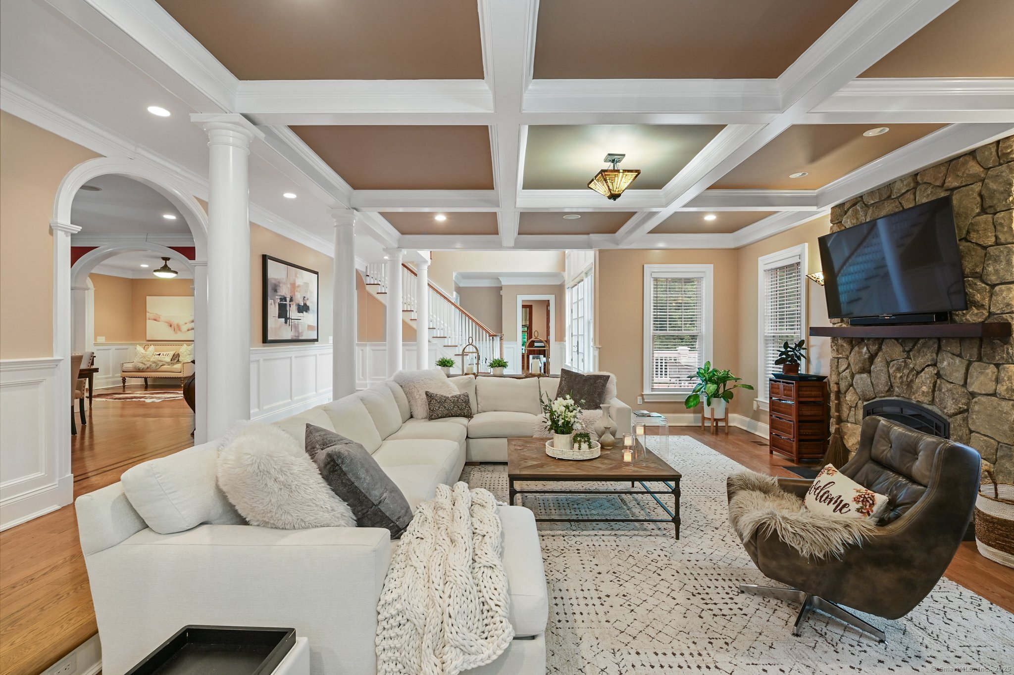 87 Buckingham Ridge Road Wilton, CT 06897 - Photo 15 of 39 a living room with fireplace furniture and a flat screen tv