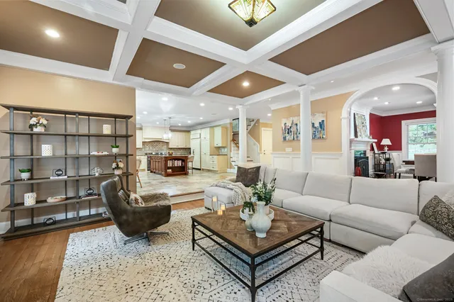 a living room with furniture a rug and a chandelier