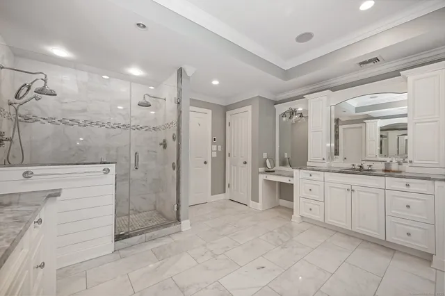 a bathroom with a granite countertop sink mirror and shower