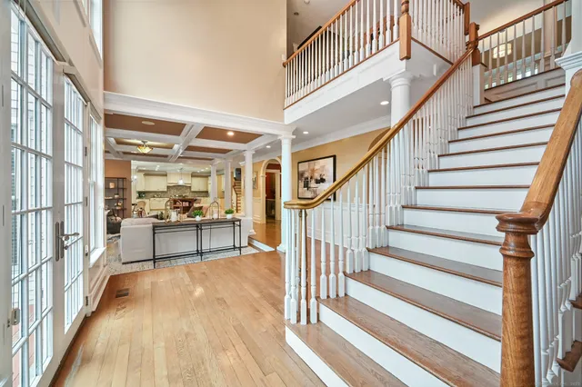 a view of entryway and hall with wooden floor