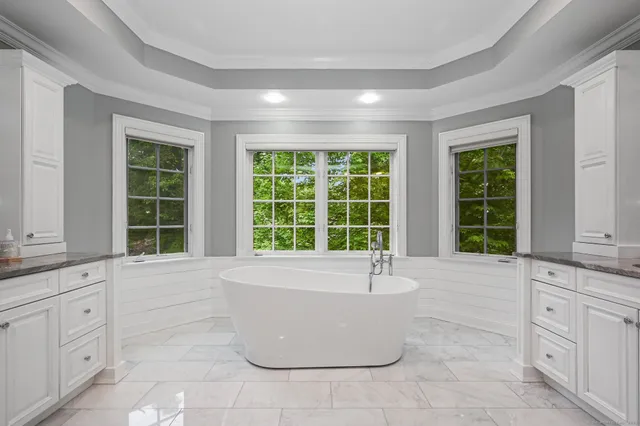 a view of a walk in closet with clothes and shoes