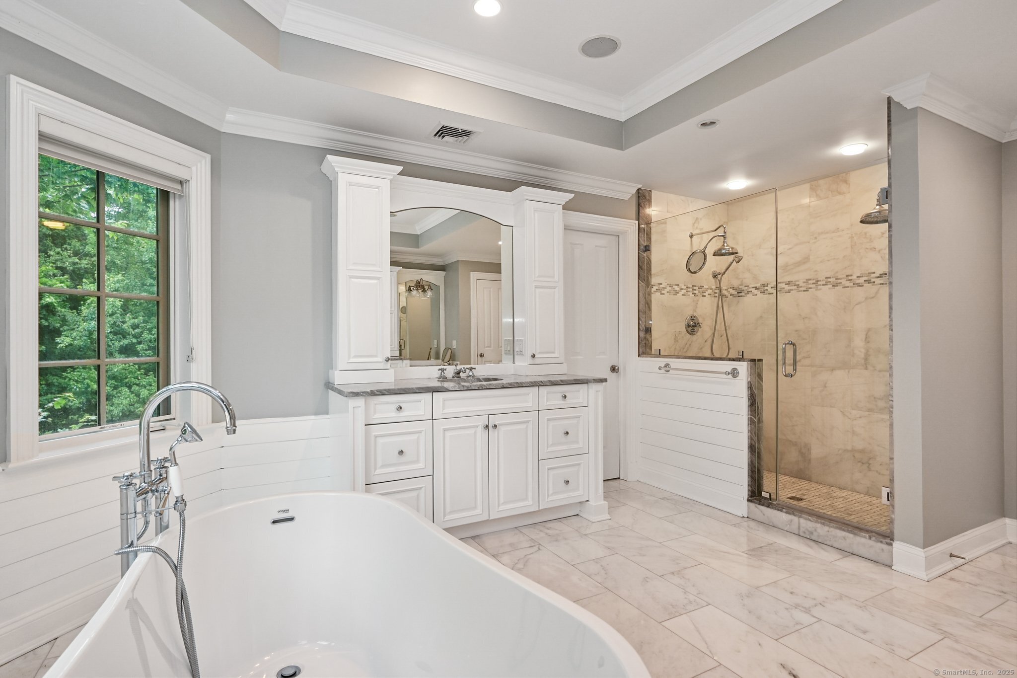87 Buckingham Ridge Road Wilton, CT 06897 - Photo 31 of 39 a spacious bathroom with a shower sink and mirror with bathtub
