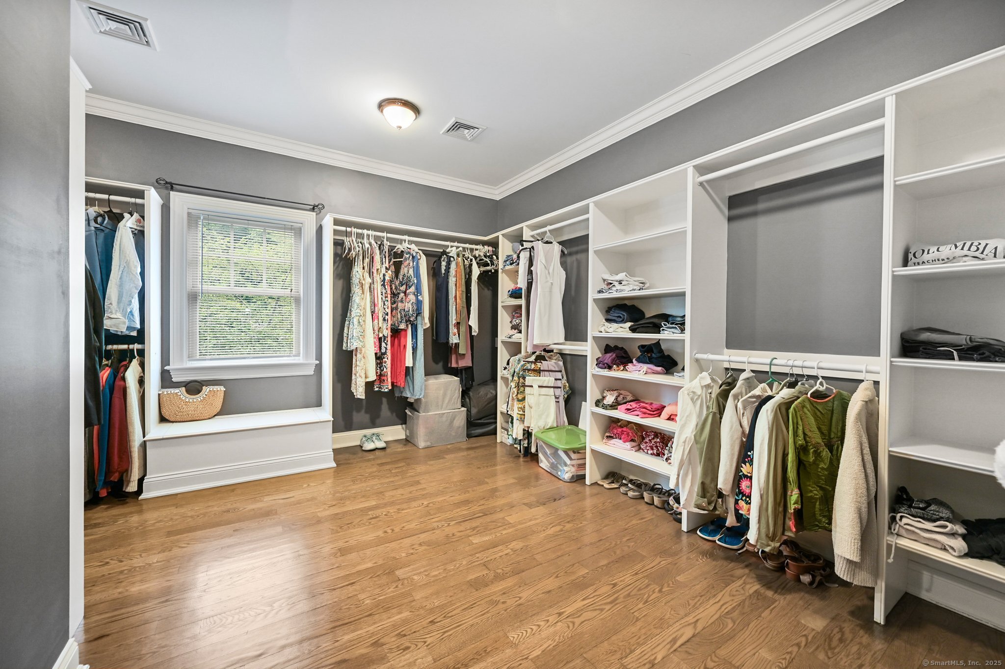 87 Buckingham Ridge Road Wilton, CT 06897 - Photo 32 of 39 a view of a walk in closet with clothes and shoes