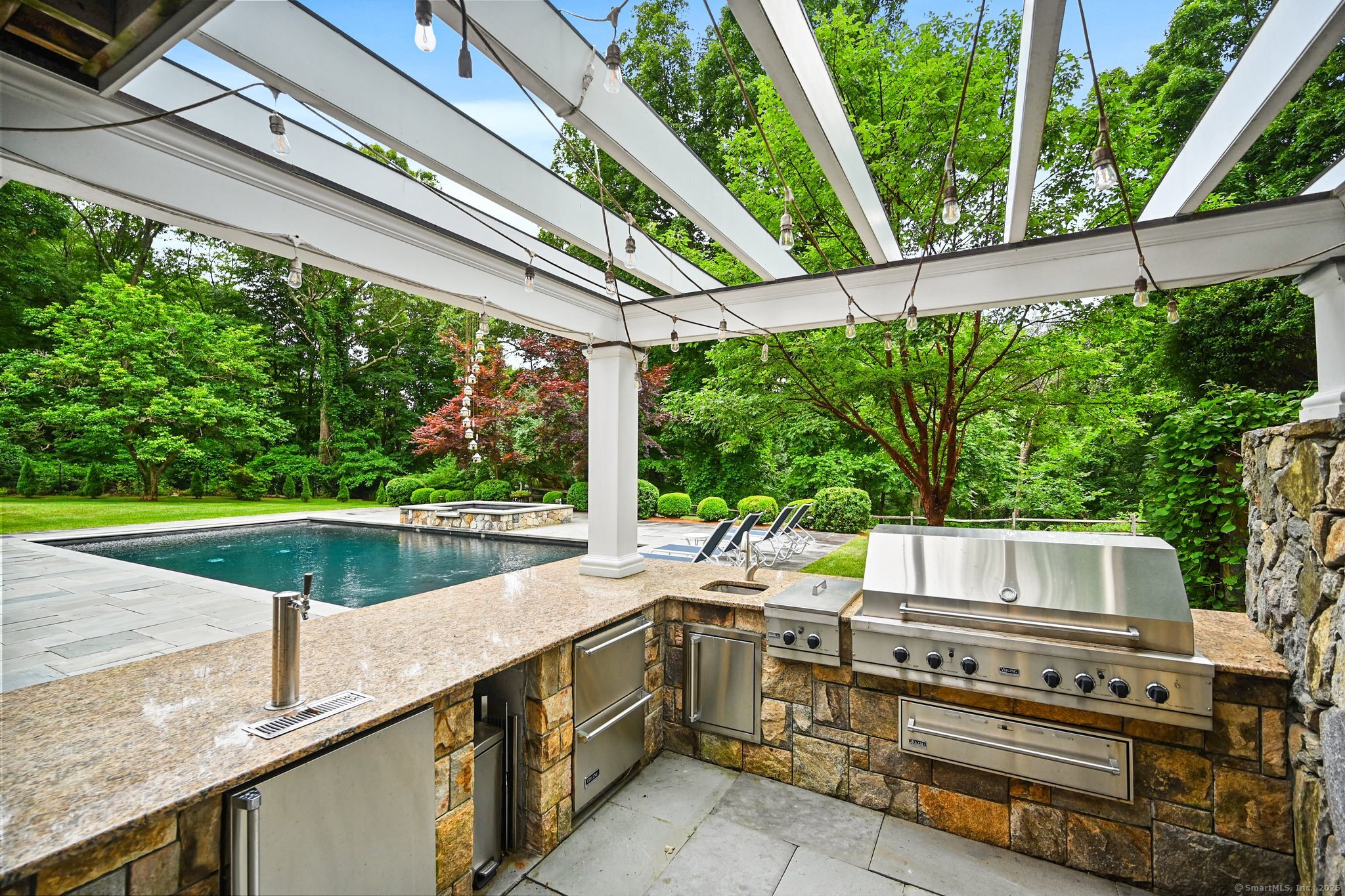 87 Buckingham Ridge Road Wilton, CT 06897 - Photo 34 of 39 a view of a patio with table and chairs potted plants with wooden floor and fence