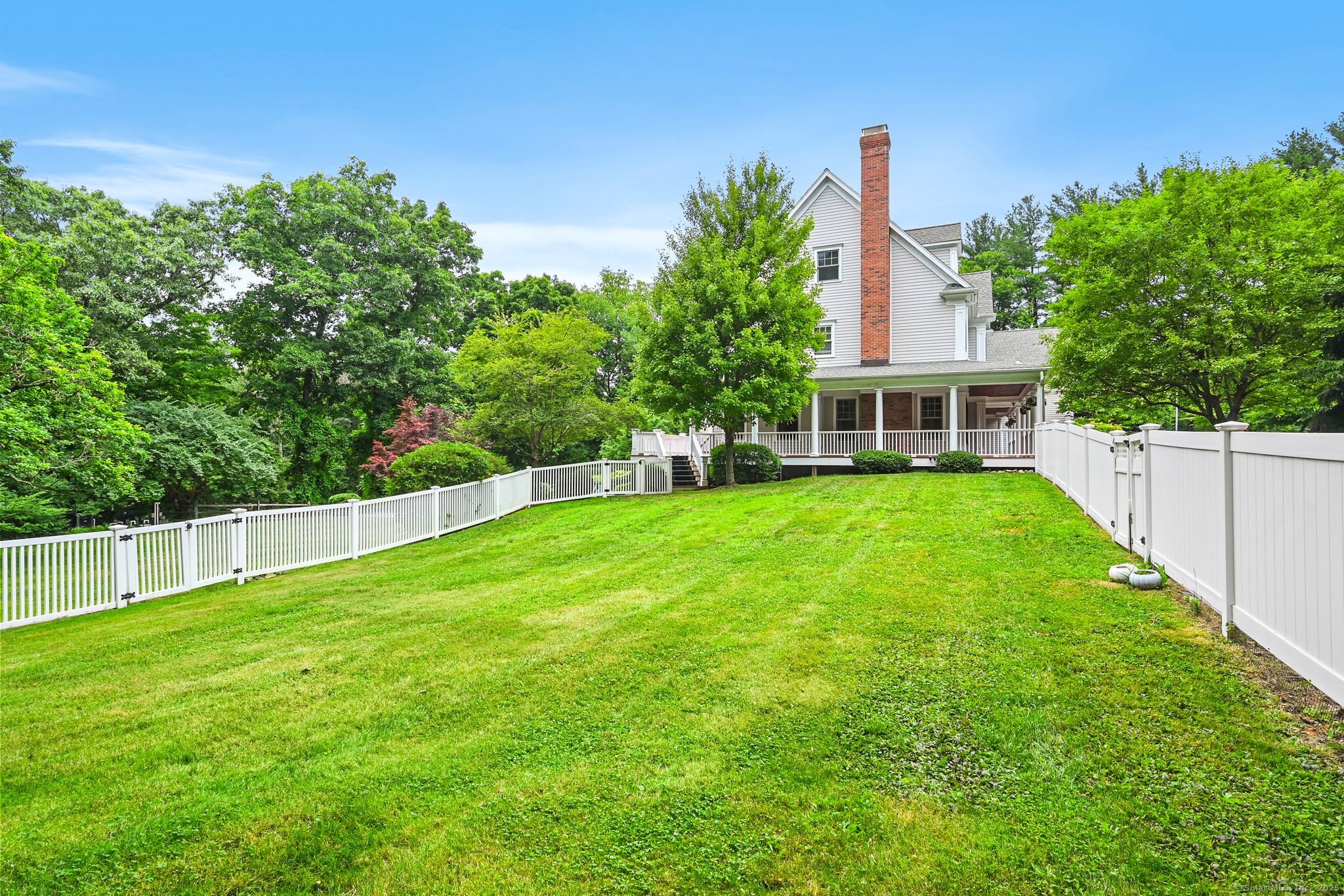 87 Buckingham Ridge Road Wilton, CT 06897 - Photo 36 of 39 a view of house with a big yard potted plants and large tree