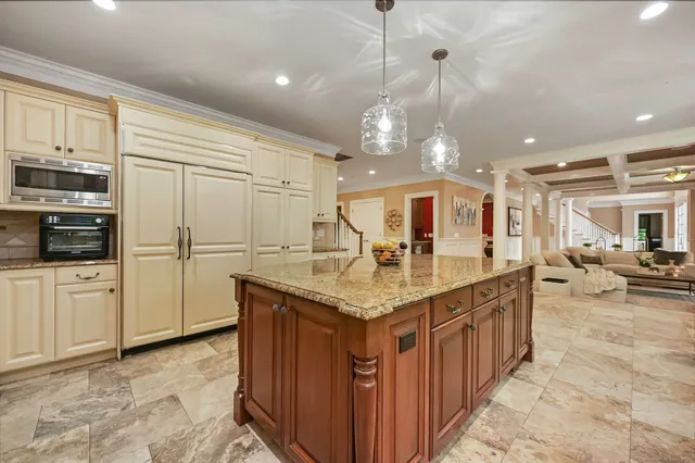 a kitchen with stainless steel appliances granite countertop a sink a stove and a refrigerator