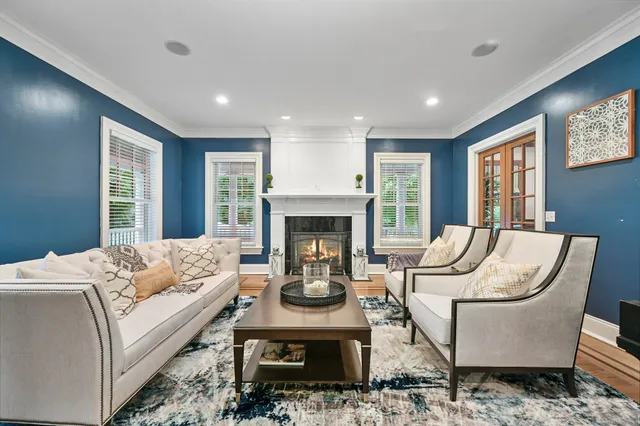 a living room with furniture fireplace and window