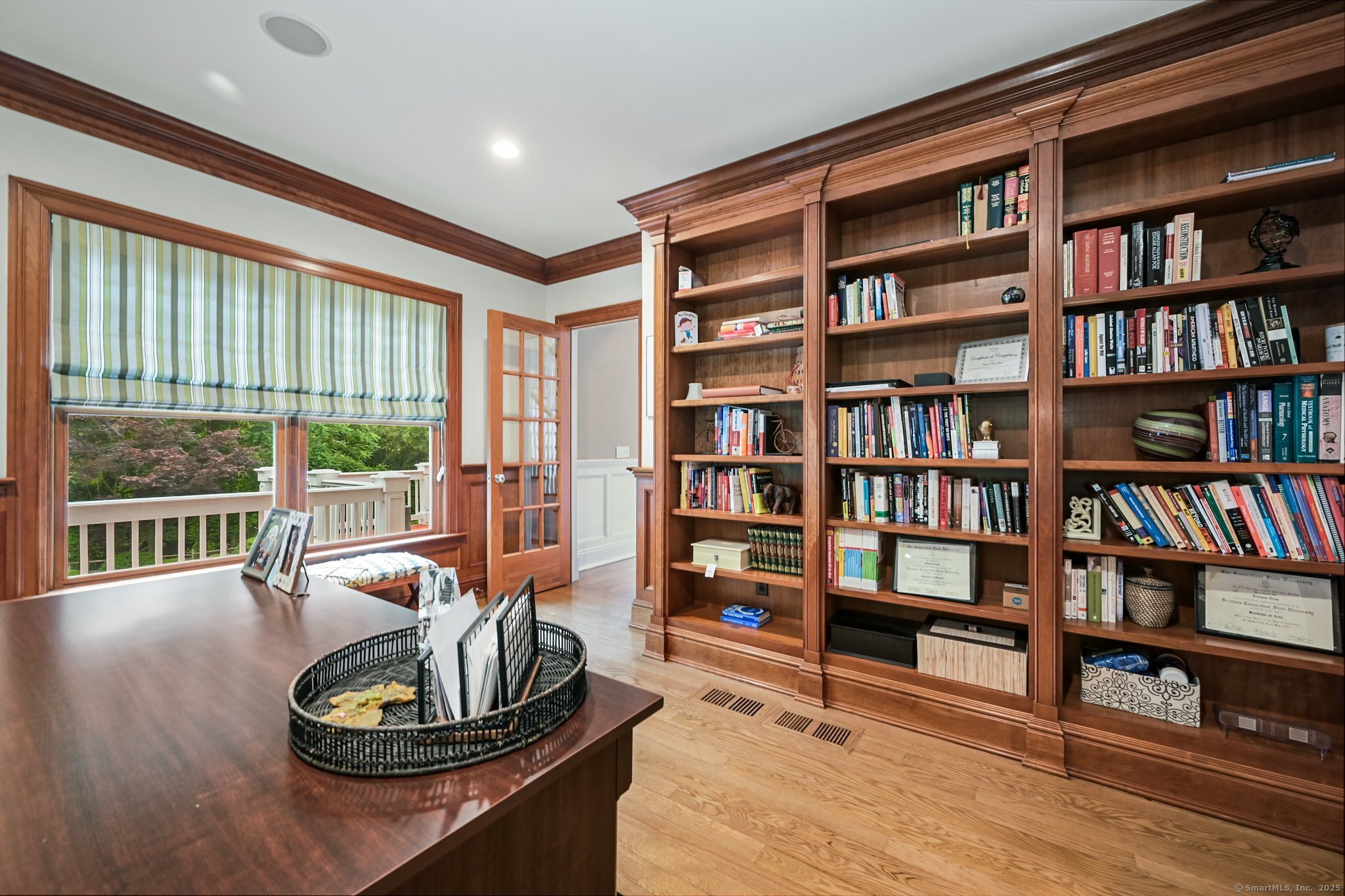 87 Buckingham Ridge Road Wilton, CT 06897 - Photo 10 of 39 a living room with furniture and a book shelf