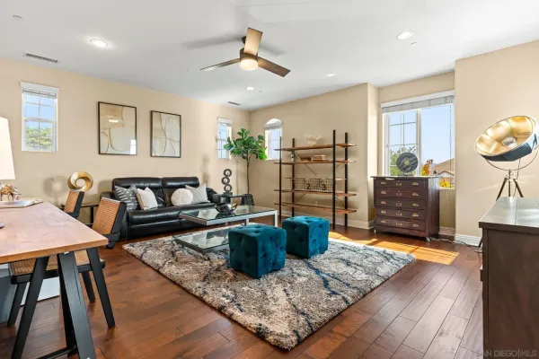 a living room with furniture and a potted plant